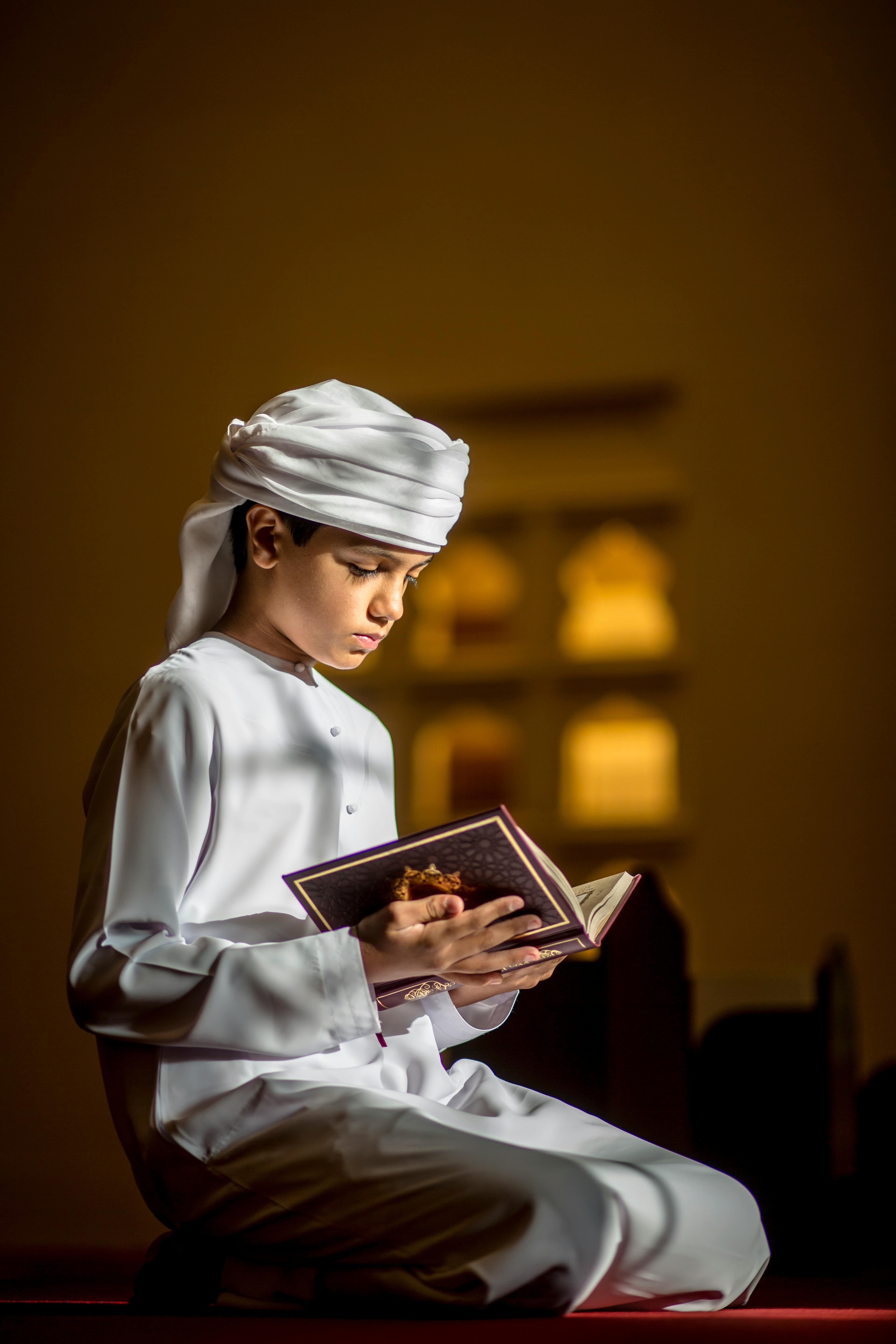 Boy reading Quran in a mosque